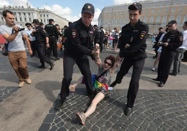 A demonstrator is detained by police during the LGBT (lesbian, gay, bisexual, and transgender) community rally in central St. Petersburg, Russia on August 4, 2018. (Photo by Sergey Konkov/Reuters)