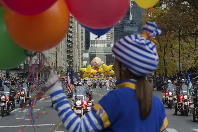 A character with balloons marches in the Macy's Thanksgiving Day Parade, Thursday, November 24, 2016, in New York. (Photo by Bryan R. Smith/AP Photo)