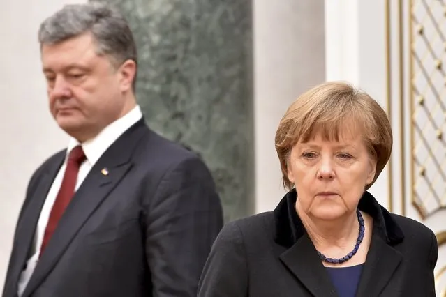 Ukraine's President Petro Poroshenko (L) and Germany's Chancellor Angela Merkel take part in peace talks on resolving the Ukrainian crisis in Minsk, February 11, 2015. (Photo by Kirill Kudryavtsev/Reuters)