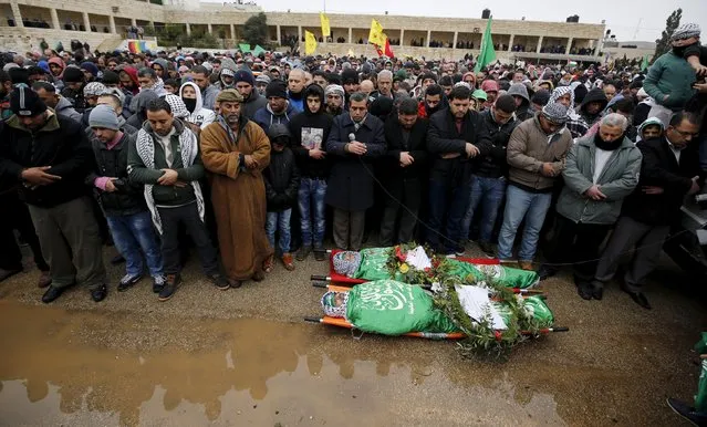 Mourners pray next to the bodies of Palestinians, who allegedly carried out attacks against Israelis, after their bodies were released by Israel, during their funeral in Silwad near the West Bank city of Ramallah January 3, 2016. (Photo by Mohamad Torokman/Reuters)