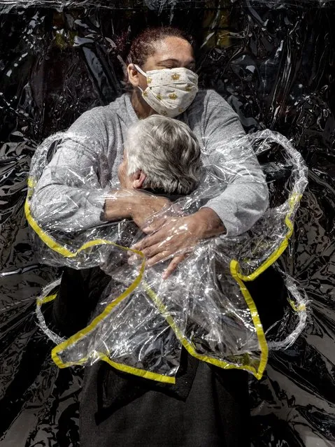 In this image released by World Press Photo, Thursday April 15, 2021, by Mads Nissen, Politiken, Panos Pictures, which won the World Press Photo of the Year award, and the first prize in the General News Singles category, titled The First Embrace, shows Rosa Luzia Lunardi (85) embraced by nurse Adriana Silva da Costa Souza, at Viva Bem care home, Sao Paulo, Brazil, on August 5, 2020. (Photo by Mads Nissen, Politiken, Panos Pictures, World Press Photo via AP Photo)