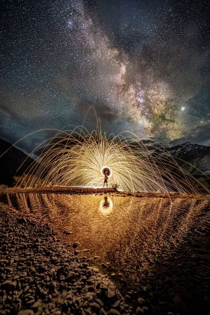 Sparks fly in front of the Milky Way. Lit steel wool is spun in front of the stunning cluster of stars and over a pool of water. The scene was pictured in May 2023 by Ganesh Bagal in the Himalayas, Himachal Pradesh, India, by using a 30 second exposure to capture the stars and movement of sparks. (Photo by Ganesh Bagal/Solent News & Photo Agency)
