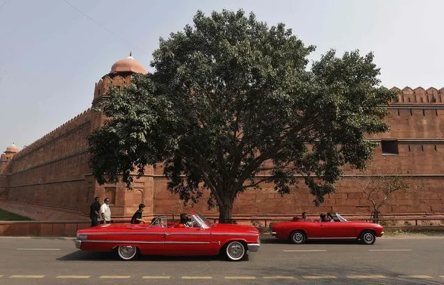 Participants drive their cars during a vintage car rally in front of the historic Red Fort in the old quarters of Delhi February 21, 2015. (Photo by Adnan Abidi/Reuters)