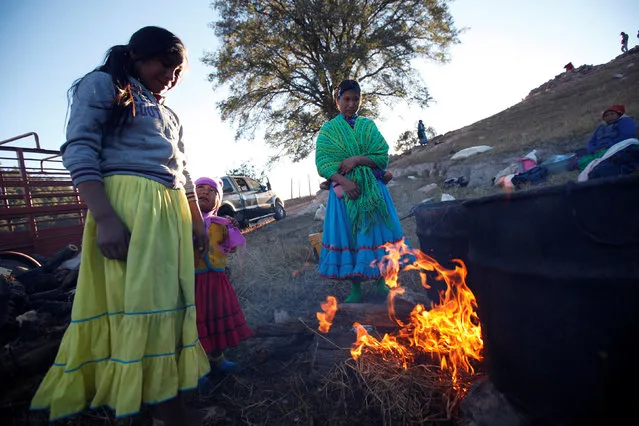 Women from the Tarahumara ethnic group keep warm by the fire while preparing for winter in Caborachi village, in Guachochi, Mexico, December 17, 2016. (Photo by Jose Luis Gonzalez/Reuters)