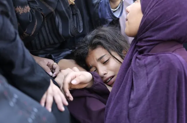 A Palestinian girl cries during the funeral of Amir Ganan, who was killed in an Israeli airstrike on the buildings in Khan Younis, Gaza Strip, Tuesday, October 10, 2023. (Photo by Hatem Ali/AP Photo)