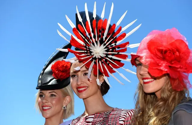 Chloe Moo (C) displays her outfit after winning in the Fashion in the Field competition at the Melbourne Cup in Melbourne on November 5, 2013. (Photo by William West/AFP Photo)