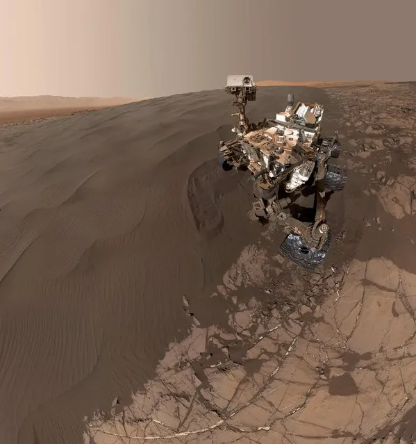 This Image obtained January 31, 2016 from NASA shows a self-portrait of NASA's Curiosity Mars rover vehicle at “Namib Dune”, where the rover's activities included scuffing into the dune with a wheel and scooping samples of sand for laboratory analysis.
The scene combines 57 images taken on January 19, 2016, during the 1,228th Martian day, or sol, of Curiosity's work on Mars. The camera used for this is the Mars Hand Lens Imager (MAHLI) at the end of the rover's robotic arm. (Photo by AFP Photo/NASA/JPL-Caltech/MSSS)