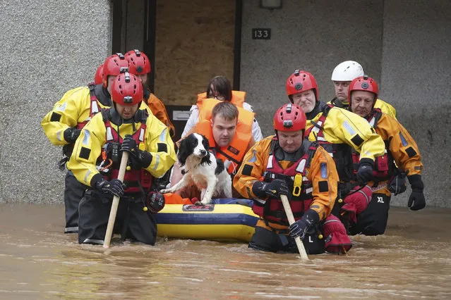 Members of the emergency services evacuate local residents from a flooded area in Brechin, Scotland, Friday October 20, 2023. The gale-force winds are expected to hit hardest the eastern part of Denmark's Jutland peninsula and the Danish islands in the Baltic Sea. But the British Isles, southern Sweden, northern Germany and parts of Norway also on the path of the storm, named Babet by U.K.’s weather forecaster, the Met Office. (Photo by Andrew Milligan/PA Wire/PA via AP Photo)