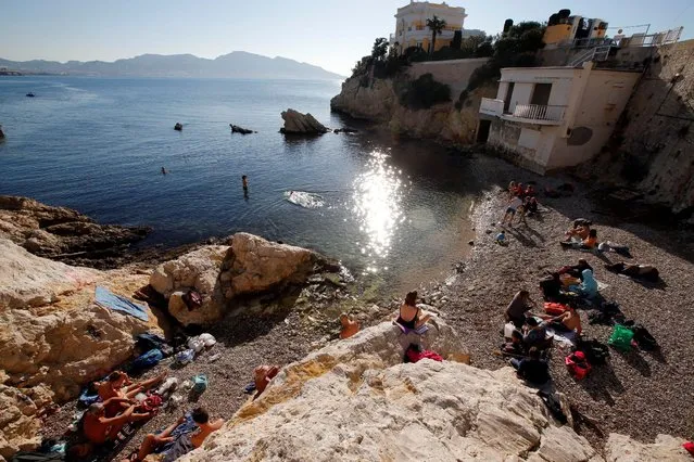 People sunbathe during a warm and sunny winter day in Marseille, France, December 29, 2016. (Photo by Jean-Paul Pelissier/Reuters)
