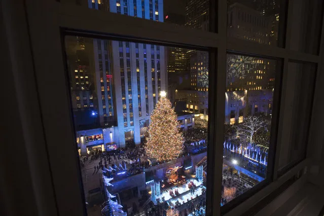 The Rockefeller Center Christmas tree is lit during the 86th annual Rockefeller Center Christmas tree lighting ceremony, Wednesday, November 28, 2018, in New York. (Photo by Mary Altaffer/AP Photo)