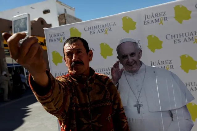 A man takes a selfie with a cardboard cut-out of Pope Francis ahead of his upcoming visit to Ciudad Juarez, Mexico, February 11, 2016. (Photo by Jose Luis Gonzalez/Reuters)