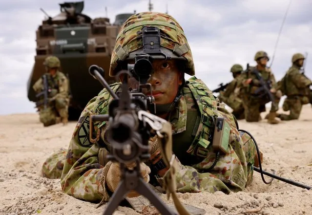 Japanese Ground Self-Defense Force's Amphibious Rapid Deployment Brigade (ARDB) soldiers take part in a marine landing drill as a part of the country's nationwide 05JX military exercises at Tokunoshima island, Kagoshima prefecture, southwestern Japan on November 19, 2023. (Photo by Issei Kato/Reuters)