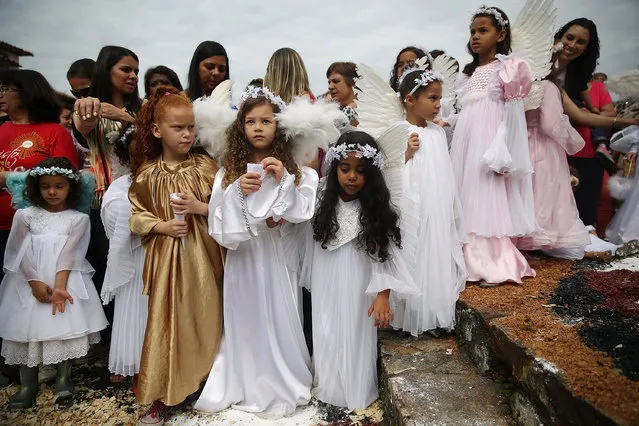 Girls are dressed as angels during the annual Easter procession during traditional Semana Santa (Holy Week) festivities on April 5, 2015 in Ouro Preto, Brazil. (Photo by Mario Tama/Getty Images)