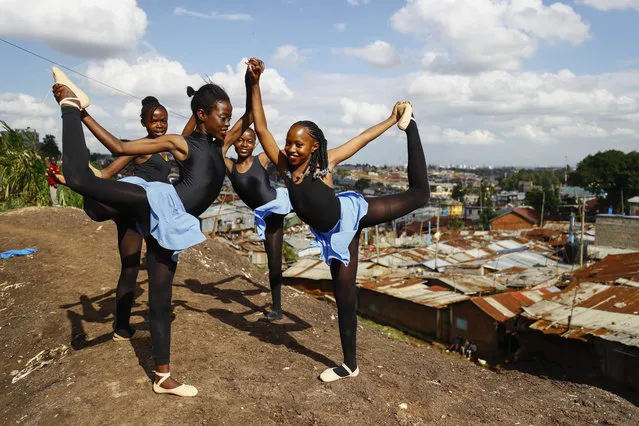 Young dancers practice by the Kenya – Uganda railway line, prior to the start of a Christmas ballet event in Kibera, the Kenyan capital's largest slum, Friday, December 15, 2023. The ballet project is run by Project Elimu, a community-driven nonprofit that offers after-school arts education and a safe space to children in Kibera. (Photo by Brian Inganga/AP Photo)