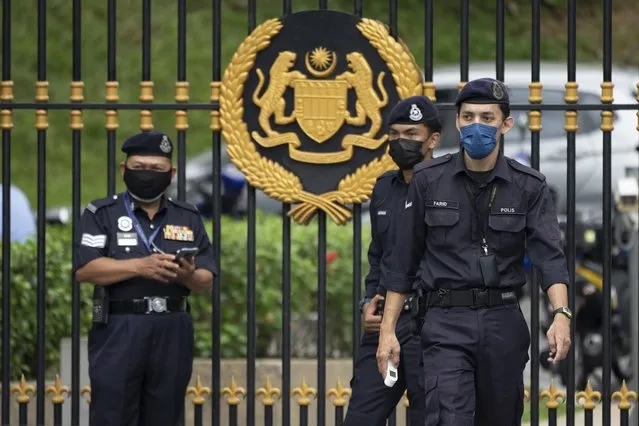 Police officers wearing face masks guard outside National Palace in Kuala Lumpur, Malaysia, Thursday, June 10, 2021. (Photo by Vincent Thian/AP Photo)