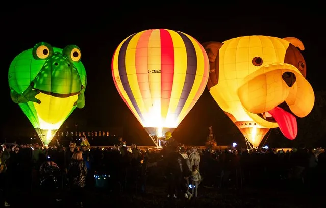 Balloons are illuminated during the Balloon Night Glow event, part of the Yorkshire Balloon Fiesta at Castle Howard in York, UK on Sunday, August 27, 2023. (Photo by Danny Lawson/PA Images via Getty Images)
