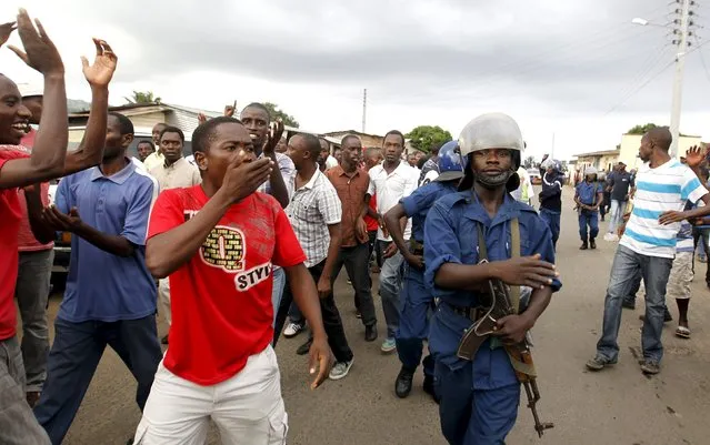 Residents participate in street protests against the decision made by Burundi's ruling National Council for the Defence of Democracy-Forces for the Defence of Democracy (CNDD-FDD) party to allow President Pierre Nkurunziza to run for a third five-year term in office, in the capital Bujumbura, April 26, 2015. (Photo by Thomas Mukoya/Reuters)