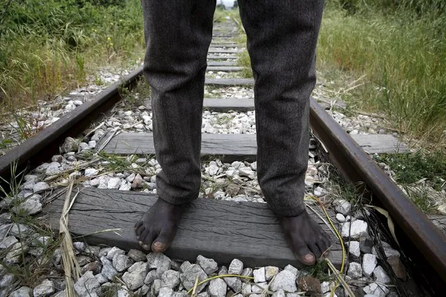 26-year-old Azam from South Sudan stands on rail tracks after failing to flee to Italy in the western Greek town of Patras April 28, 2015. (Photo by Yannis Behrakis/Reuters)