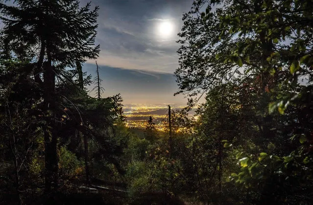 The moon shines over the nocturnal plain of the Main at the view of the Altkönig, the third highest mountain in the Taunus at 798.2 meters on September 18, 2018 in Hessen, Kronberg. (Photo by Frank Rumpenhorst/DPA)