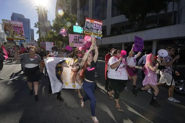 Britney Spears supporters march On Grand Avenue while a hearing concerning the pop singer's conservatorship is held the Stanley Mosk Courthouse, Friday, November 12, 2021, in Los Angeles. (Photo by Damian Dovarganes/AP Photo)