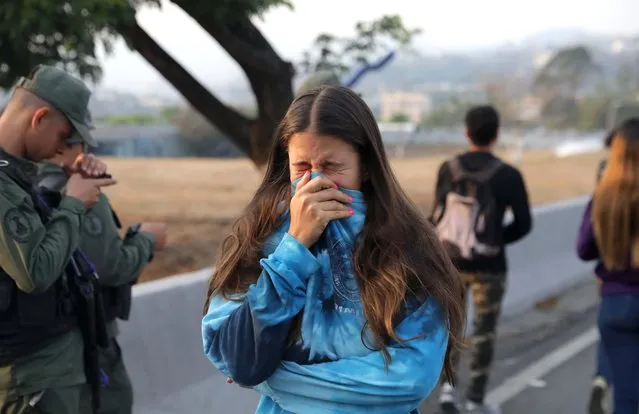 A woman reacts to tear gas near the Generalisimo Francisco de Miranda Airbase in Caracas, Venezuela April 30, 2019. (Photo by Manaure Quintero/Reuters)