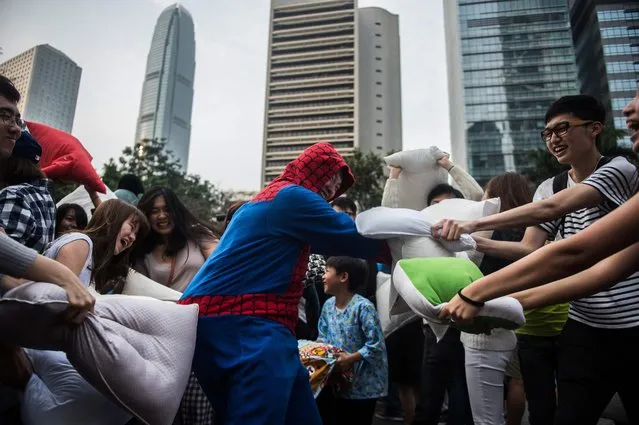 People participate in Hong Kong's sixth annual pillow fight on April 2, 2016. (Photo by Anthony Wallace/AFP Photo)