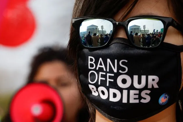 A demonstrator for abortion rights wearing a face mask takes part in a protest outside the U.S. Supreme Court as justices hear oral arguments in a bid by President Joe Biden's administration to preserve broad access to the abortion pill, in Washington, on March 26, 2024. (Photo by Evelyn Hockstein/Reuters)