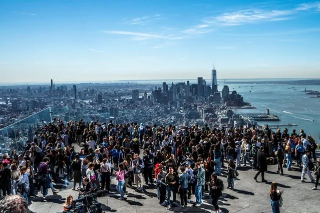 People gather on the observation deck of Edge at Hudson Yards before a partial solar eclipse in New York City, New York, U.S., April 8, 2024. (Photo by Eduardo Munoz/Reuters)