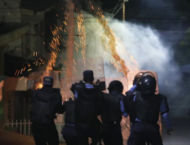 Riot police fire teargas, during a night of rioting in Tegucigalpa, Honduras, late Thursday, June 20, 2019. Protesters blockaded highways, clashed with police as part of demonstrations against President Juan Orlando Hernández. (Photo by Elmer Martinez/AP Photo)
