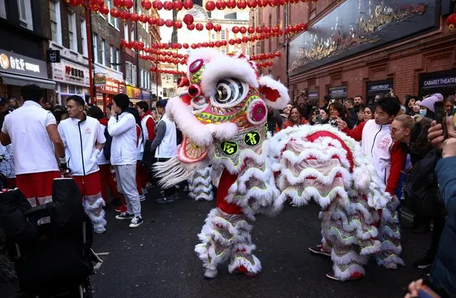 A Chinese lion dance is performed in Chinatown during Lunar New Year celebrations in London, Britain on January 21, 2023. (Photo by Henry Nicholls/Reuters)