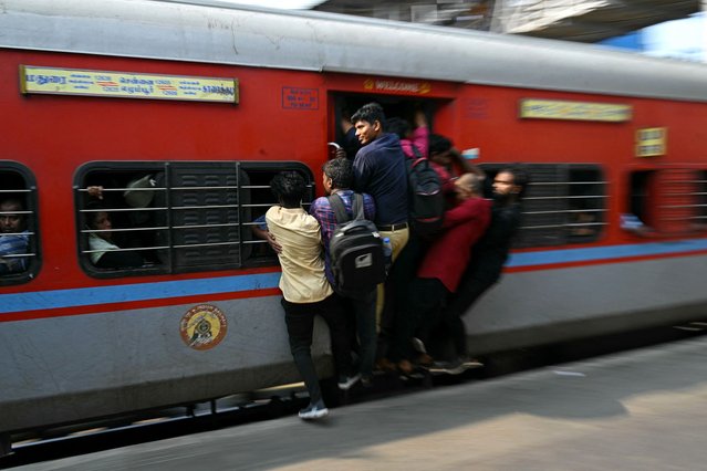 People travel in an overcrowded train to their hometowns on the eve of the first phase of voting for the country's general election, at a railway station in Chennai on April 18, 2024. Nearly a billion Indians will vote to elect a new government in six-week-long parliamentary polls starting on April 19, the largest democratic exercise in the world. (Photo by R.Satish Babu/AFP Photo)