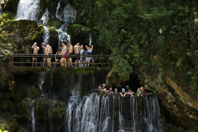 Tourists soak in the water at the ‘world’s largest’ hot spring waterfall deep in the mountains of south-west China’s Sichuan province, Xichang, China on June 21, 2019. (Photo by Costfoto/Barcroft Media)
