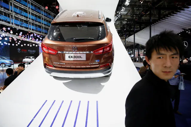 People gather around vehicles presented at Beijing Automotive Group (BAIC) booth during Auto China 2016 auto show in Beijing April 25, 2016. (Photo by Damir Sagolj/Reuters)