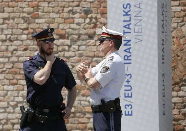 Two policemen guard Palais Coburg, the venue for nuclear talks in Vienna, Austria, July 1, 2015. Iran and six world powers gave themselves an extra week to reach a final nuclear accord after it became clear they would miss a deadline on Tuesday, with U.S. and Iranian officials sounding upbeat even though obstacles remain. (Photo by Leonhard Foeger/Reuters)