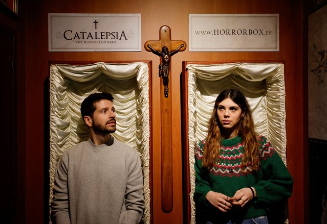 A couple of gamers, Miriam Castella and Carlos Granedo, participate in an extreme escape room named Catalepsia, which takes place inside two coffins simulating their funeral and trying to escape from them by working in pairs to solve puzzles and tricks, in Barcelona, Spain, on January 18, 2024. (Photo by Albert Gea/Reuters)