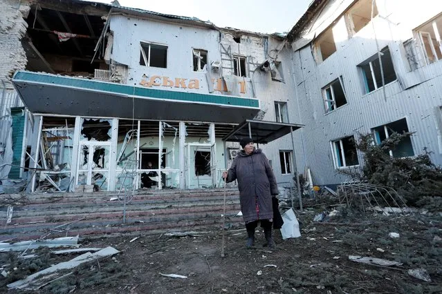 A woman stands outside a local hospital, which was destroyed during Ukraine-Russia conflict in the separatist-controlled town of Volnovakha in the Donetsk region, Ukraine on March 12, 2022. (Photo by Alexander Ermochenko/Reuters)