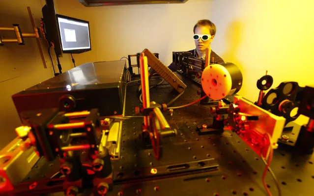 Dissertation student Jan Torgersen of Vienna University of Technology operates a newly developed 3D laser printer, in Vienna March 29, 2012. Torgersen and colleagues have set a new world speed record for creating 3D nano objects. (Photo by Herwig Prammer/Reuters)