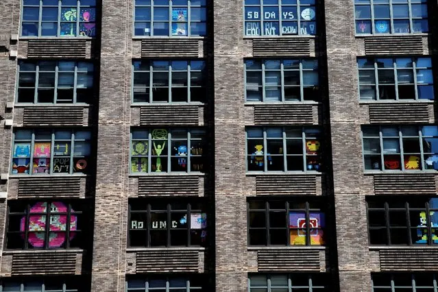 Images created with Post-it notes are seen in the windows of offices at 75 Varick Street in lower Manhattan, New York, U.S., May 18, 2016. (Photo by Mike Segar/Reuters)