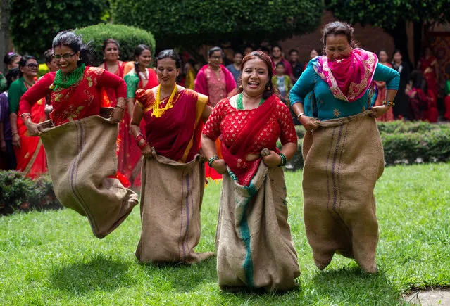 Women of the non-profit organization Maiti Nepal, a Rehabilitation and Orphanage home for HIV affected and trafficking women and children, play during a function to celebrate Teej festival in Kathmandu, Nepal, 29 August 2019. Maiti Nepal organized the event to help HIV positive and trafficking women and children and educate about the festival. The Teej festival is the biggest festival for Nepalese Hindu women. During the festival married women take a fast for the long and prosperous life of their husbands and unmarried women celebrate to get a good one by fasting for a day. The Teej festival will be celebrated on 02 September. (Photo by Narendra Shrestha/EPA/EFE)