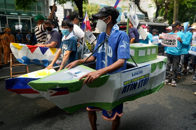 Filipino fishermen and activists wear boat costumes to protest against alleged Chinese aggression at the disputed South China Sea as they stage a rally in front of the Chinese consulate ahead of Independence Day in Makati, Philippines on Tuesday, June 11, 2024. (Photo by Aaron Favila/AP Photo)