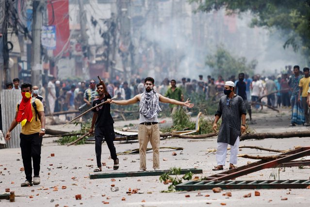 A demonstrator gestures as protesters clash with Border Guard Bangladesh (BGB) and the police outside the state-owned Bangladesh Television as violence erupts across the country after anti-quota protests by students, in Dhaka, Bangladesh, on July 19, 2024. (Photo by Mohammad Ponir Hossain/Reuters)