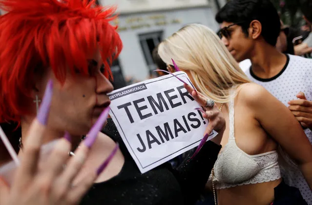 Revellers take part in the annual Gay Pride parade along Paulista Avenue in Sao Paulo, Brazil, May 29, 2016. The sign reads: “Never Temer”, in reference to Brazil's interim President Michel Temer. (Photo by Nacho Doce/Reuters)