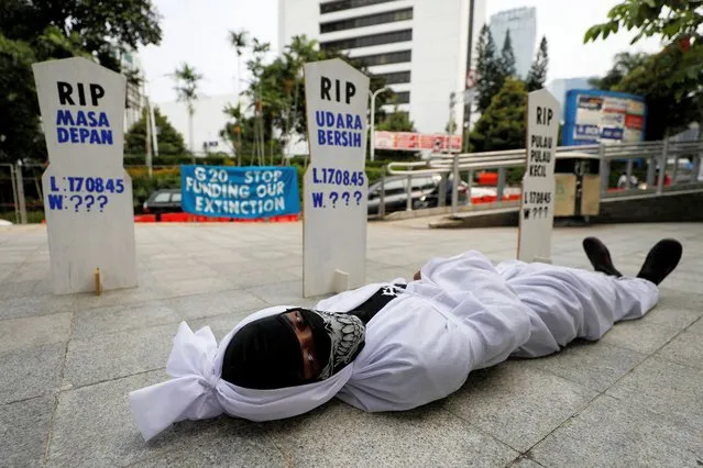 An activist takes part in a protest urging governments to act against climate change and social injustice in Jakarta, Indonesia, March 25, 2022. (Photo by Willy Kurniawan/Reuters)