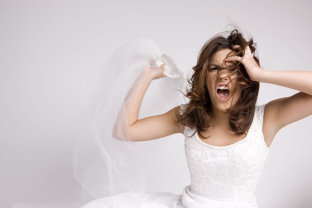 Angry screaming bride throwing veil. (Photo by quavondo/Getty Images)