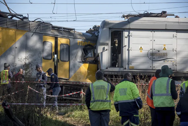 Emergency services and police work at the scene of a train crash near Johannesburg, Thursday, June 1, 2017. South African paramedics say a train driver was killed and 50 other people were injured in the collision at a station near Johannesburg. (Photo by AP Photo)