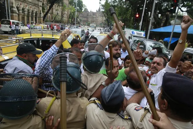 India's Bharatiya Janata Party (BJP) activists supporting death penalty of 1993 Mumbai blasts accused Yakub Abdul Razak Memon, are stopped by police during a protest in Mumbai, India, Wednesday, July 29, 2015. Memon, an accountant, convicted of providing financial and logistical support in the series of bombings that shook India's business and entertainment hub in 1993 is scheduled to be hanged Thursday, July 30, 2015. (Photo by Rafiq Maqbool/AP Photo)