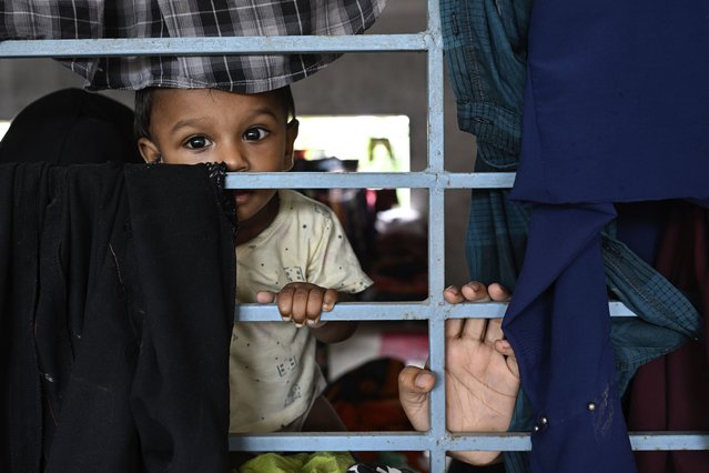 A young child reacts to the camera at a relief shelter for people displaced by floods in Mohipal, Feni, a coastal district in southeast Bangladesh, Friday, August 23, 2024. (Photo by Fatima Tuj Johora/AP Photo)