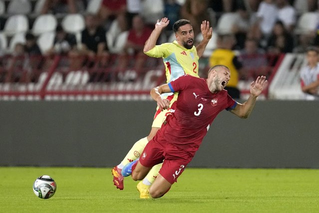 Spain's Dani Carvajal, left, fouls Serbia's Strahinja Pavlovic during the UEFA Nations League soccer match between Serbia and Spain at the Rajko Mitic Stadium, in Belgrade, Serbia, Thursday, September 5, 2024. (Photo by Darko Vojinovic/AP Photo)