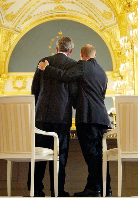 Russian President Vladimir Putin, right, puts his arm around President Bush after the two leaders signed  an arms treaty at the Kremlin in Moscow, Russia, Friday, May 24, 2002. The two leaders signed a treaty cutting the number of strategic nuclear warheads over 10 years to one-third their current level, a declaration on a new strategic relationship and a statement on cooperation in the field of energy. (Photo by Doug Mills/AP Photo)