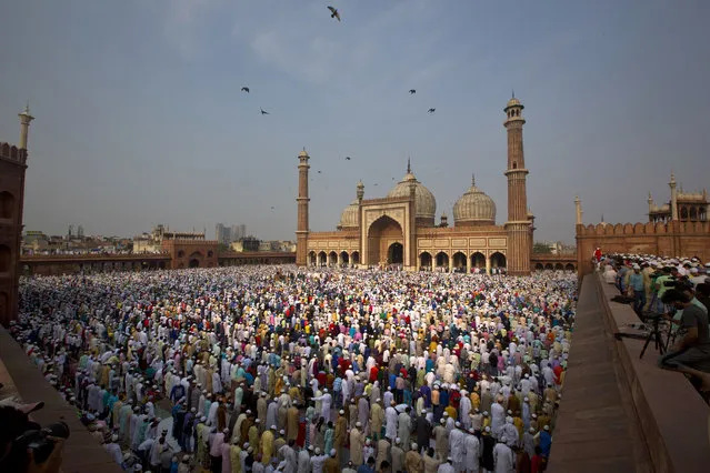 Muslims offer Eid al-Fitr prayers at the Jama Masjid mosque in New Delhi, India, Monday, June 26, 2017. Eid al-Fitr marks the end of the Muslims' holy fasting month of Ramadan. (Photo by Manish Swarup/AP Photo)